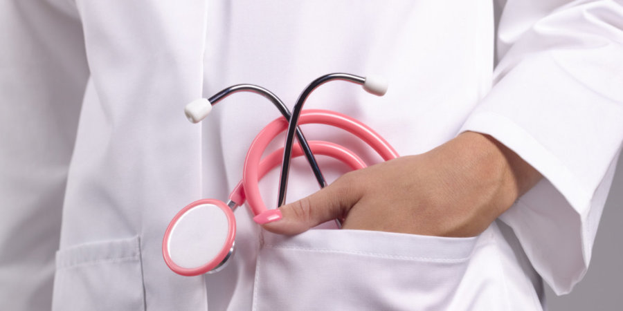 Feminine doctor with pink stethoscope in pocket