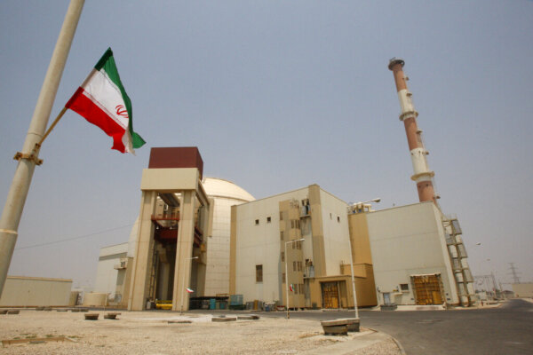An Iranian flag flutters in front of the reactor building of the Bushehr nuclear power plant, just outside the southern city of Bushehr, Iran, Saturday, Aug. 21, 2010. Iranian and Russian engineers began loading fuel Saturday into Iran's first nuclear power plant, which Moscow has promised to safeguard to prevent material at the site from being used in any potential weapons production. (AP Photo/Vahid Salemi)