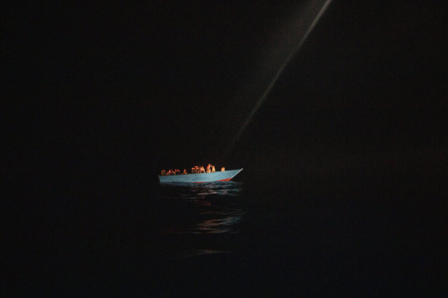Dozens of migrants, from Egypt, Morocco, Somalia and Sierra Leone, including women and minors, wait to be assisted by a team of aid workers of the Spanish NGO Open Arms, after spending more than 20 hours at sea when fleeing Libya on board a precarious wooden boat in international waters, in the Central Mediterranean sea, Tuesday, Sept. 8, 2020. (AP Photo/Santi Palacios)