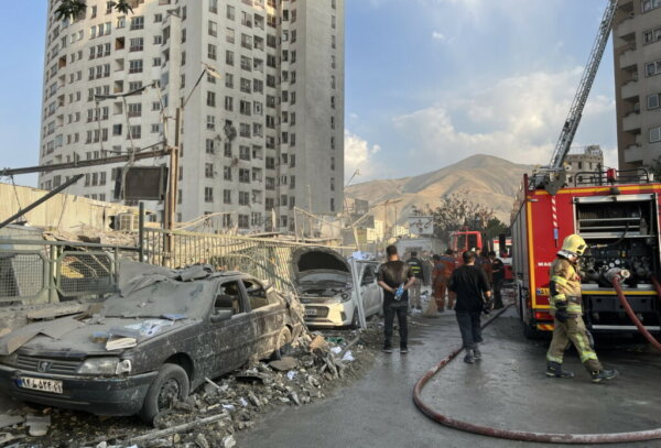 epaselect epa12172720 Fire fighters work outside a building that was hit by Israeli air strikes north of Tehran, Iran, 13 June 2025. Israel confirms it has launched strikes on Iran's 'nuclear program' as blasts are heard across the country. The strikes are part of Operation Rising Lion, Israel's Prime Minister Benjamin Netanyahu said, adding Iran was a threat to "Israel's very survival".  EPA/ABEDIN TAHERKENAREH