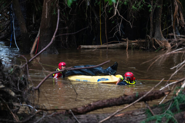 Firefighters from Ciudad Acuña, Mexico, transport a recovered body on the flooded Guadalupe River days after a flash flood swept through the area, Monday, July 7, 2025, in Ingram, Texas. (AP Photo/Eli Hartman)