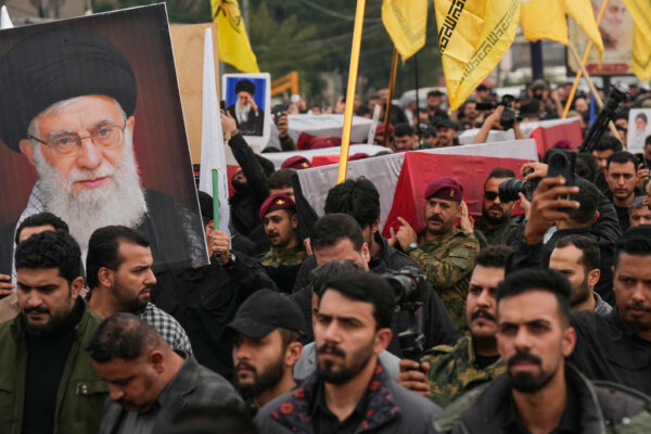 Members from the Popular Mobilization Forces participate in the funeral in Baghdad, Iraq, Tuesday, March 24, 2026, of members of the forces who were killed in a U.S. airstrike in Anbar, Iraq. (AP Photo/Hadi Mizban)