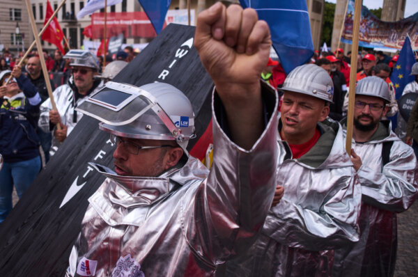 Steel workers take part in a demonstration organized by steel workers union IG Metall against the German government's economic and industrial policies, in Berlin, Germany, Friday, June 12, 2026. (AP Photo/Markus Schreiber)